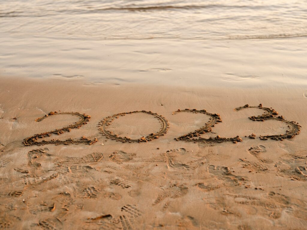 2023 written in sand on beach