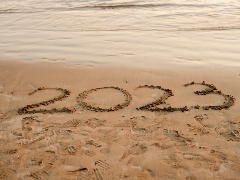 2023 written in sand on beach
